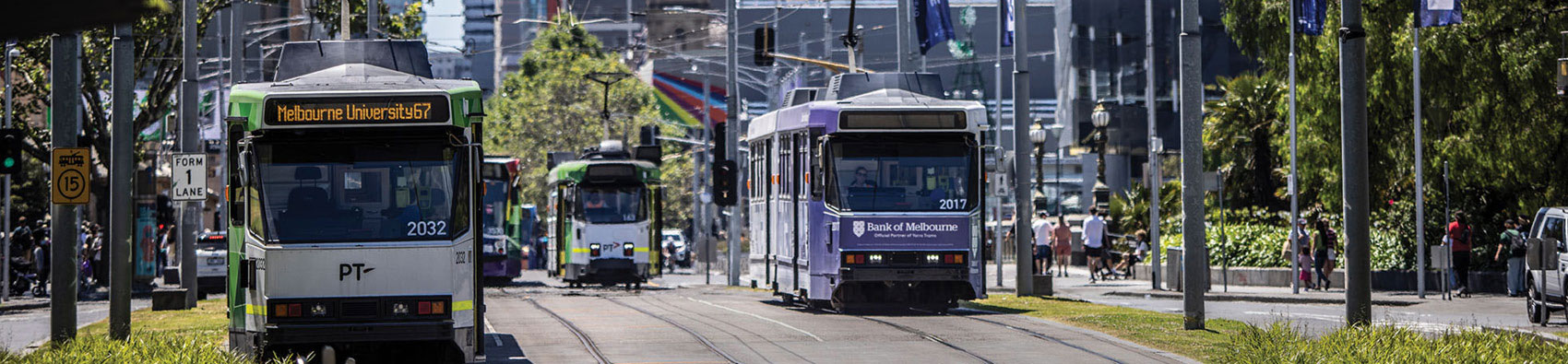 Four trams on tram lines in the city.