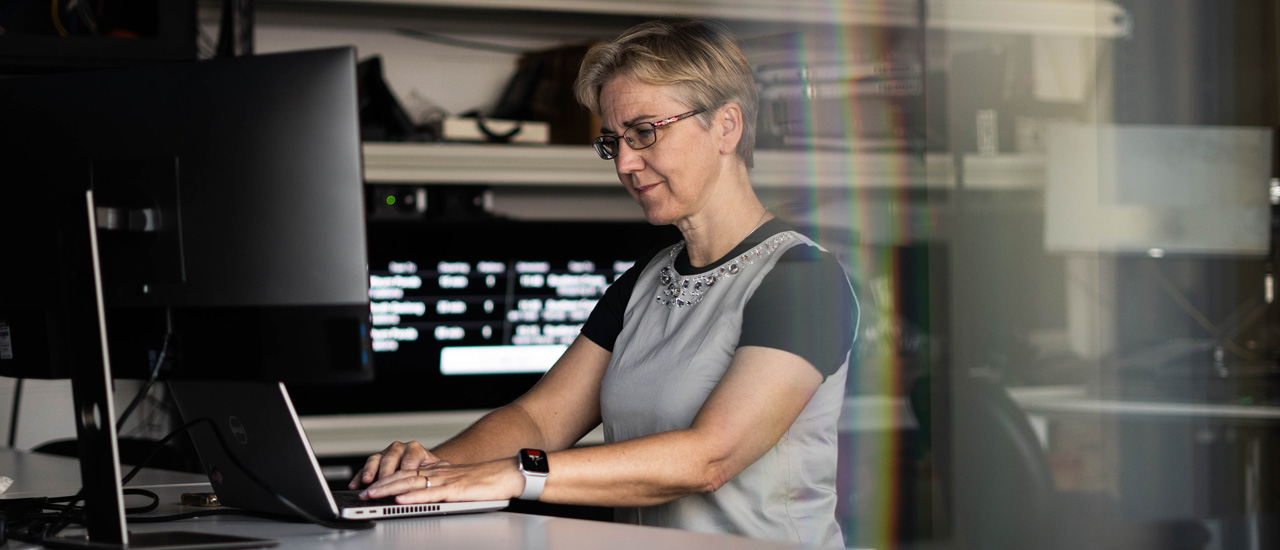 An engineer works on a computer inside a telecommunications centre